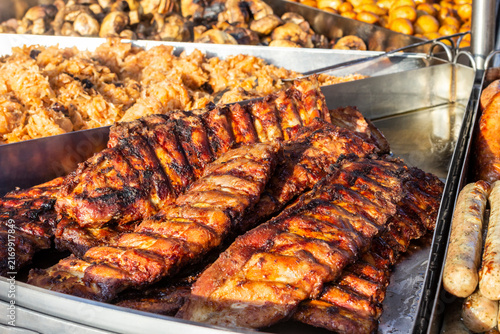 Close-up of grilled ribs among grilled meat. Street food.