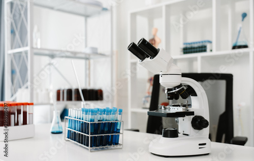Konstfotografi Scientific Discovery Laboratory: A pristine laboratory setting equipped with advanced scientific instruments, including a microscope and test tubes filled with colorful liquids