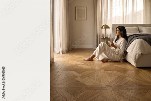 young woman sitting on the floor and looking at the camera