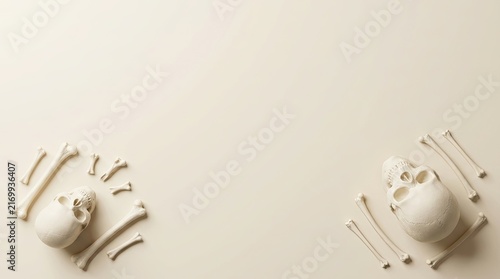 Minimalist halloween background featuring two small skulls surrounded by scattered bones on a clean beige surface