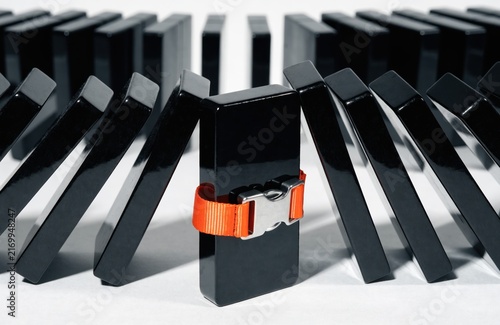 Creative Concept Chain Reaction Stopped Red Domino.