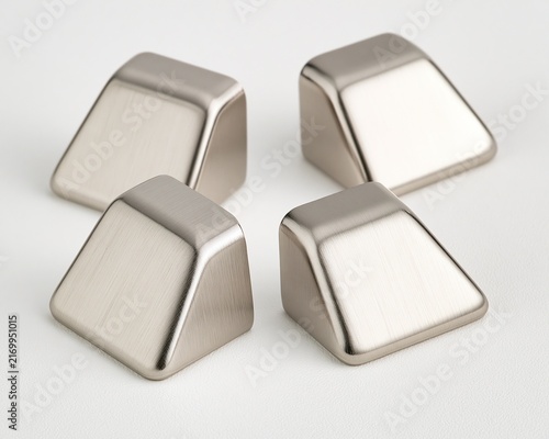 Four metallic, geometric knobs in brushed silver finish.