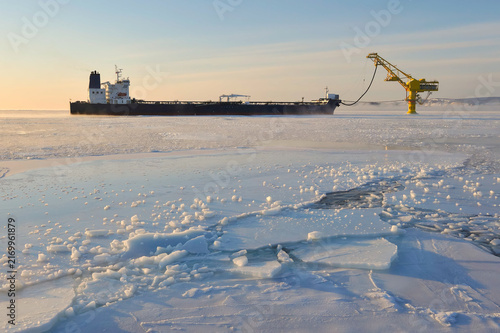 Russian oil tanker loading at De-Kastri terminal in frozen sea