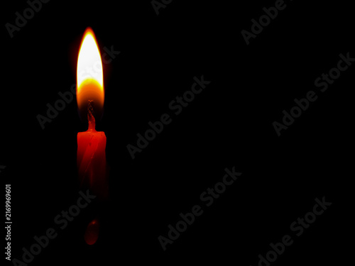 Bild auf Leinwand A close-up shot of a single lit red birthday candle burning brightly against a s