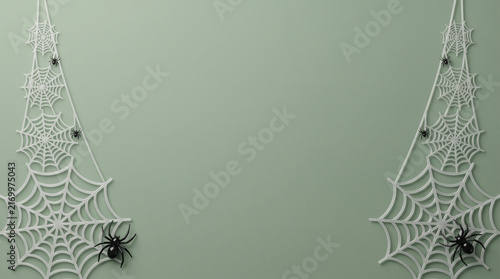 White spider webs with black spiders on a green background for Halloween party decor