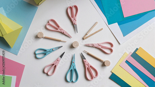 Assorted scissors and crafting tools arranged on a workspace  