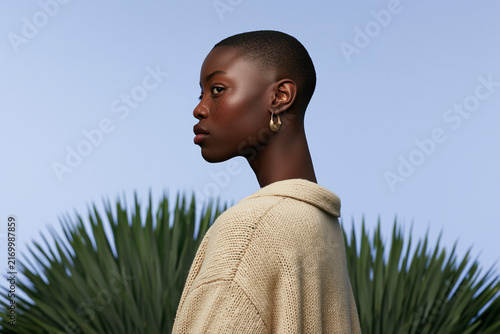 Elegant Woman Portrait Beside Tropical Palm Leaves