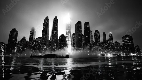 Epic Black and White View of New York City Skyline at Night with City Lights Reflected in Water