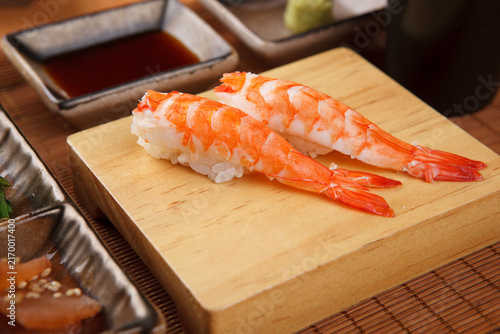 Fotografía Shrimp nigiri sushi on a wooden serving board