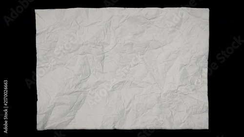 Stop motion animation of a white crumpled paper sheet unfolding and flattening out. Smooth paper texture reveal with isolated black background, perfect for transitions, title backgrounds, motion desig