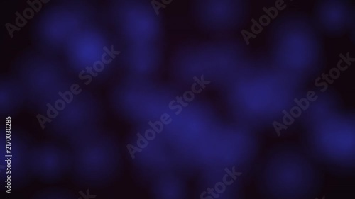 Abstract dark blue bokeh background with soft glowing light particles and smooth motion.