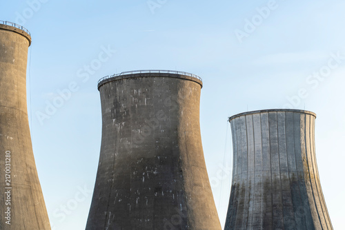 Obraz na plátne Concrete cooling towers of an old power plant against a blue sky
