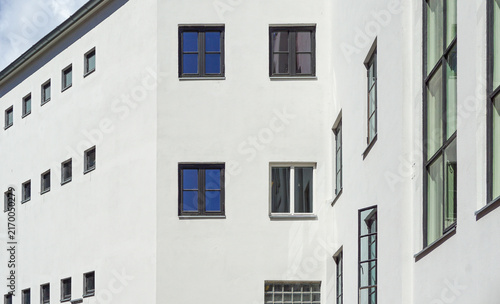 Photography Oslo white building facade with windows reflecting blue sky