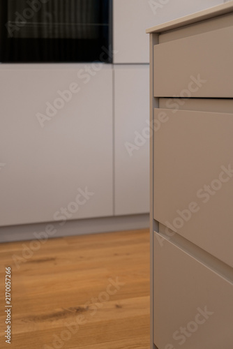Bild auf Leinwand Close-up of minimalist kitchen cabinet drawers and warm wood flooring in a moder