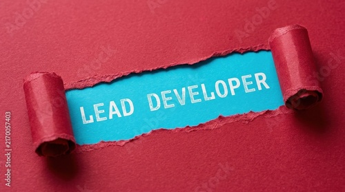 Lead Developer Text Revealed Under Torn Red Paper Background