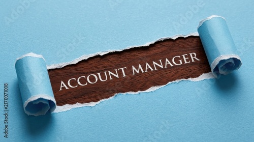 Account Manager Text Revealed Under Torn Blue Paper Background