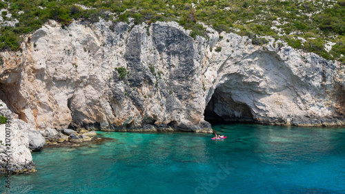 фотографія Clear turquoise water and limestone sea cave at Porto Limnionas, Zakynthos, Gree