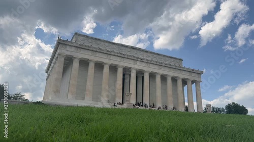 Low angle timelapse view of the Lincoln Memorial in Washington, DC, with visitors moving around the landmark beneath dramatic passing clouds. 15328  