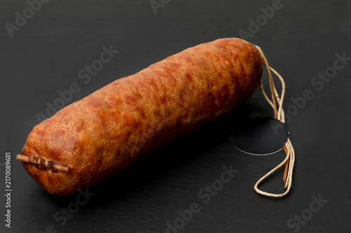 Fotografía Smoked pork sausage on a black background