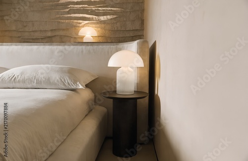 Luxury bedroom detail with bedside lamp and textured wall