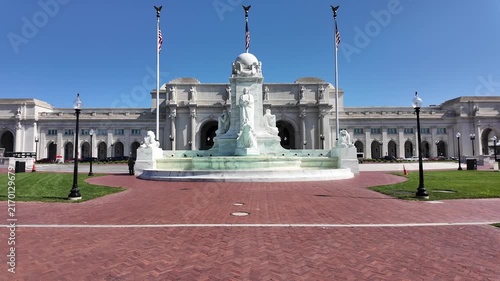 Tilt up establishing shot of Washington Union Station and the Columbus Fountain under a clear blue sky in Washington, DC. 15335  