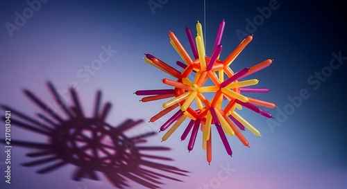 Creative spiky star shape constructed from colorful wax crayons with shadow