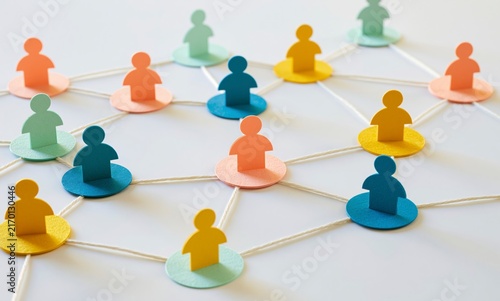 Colorful paper people connect together with string in a human network plan