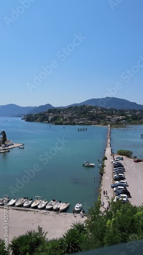 Portrait timelapse shot of planespotting causeway with boat passing by near Corfu Airport, Greece