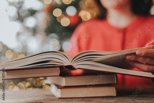  Woman Reading Books During Christmas Winter Holidays. literacy campaigns, bookstore promotions, home education