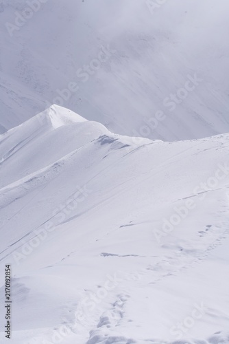 Clean lines of a wind-polished snow ridge in winter mountains, Hokkaido, Japan