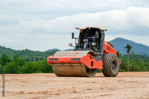 Photography Heavy machinery flattens soil at an outdoor development location during the day