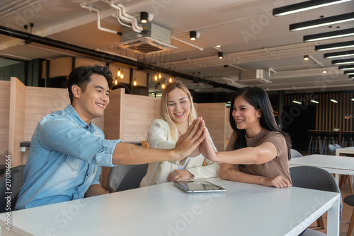 Group of powerful diversity creative people high five on air to greeting power of team. Multiethnic businesspeople working together. Collaboration in Business Team success. StrongTeamwork concept.
