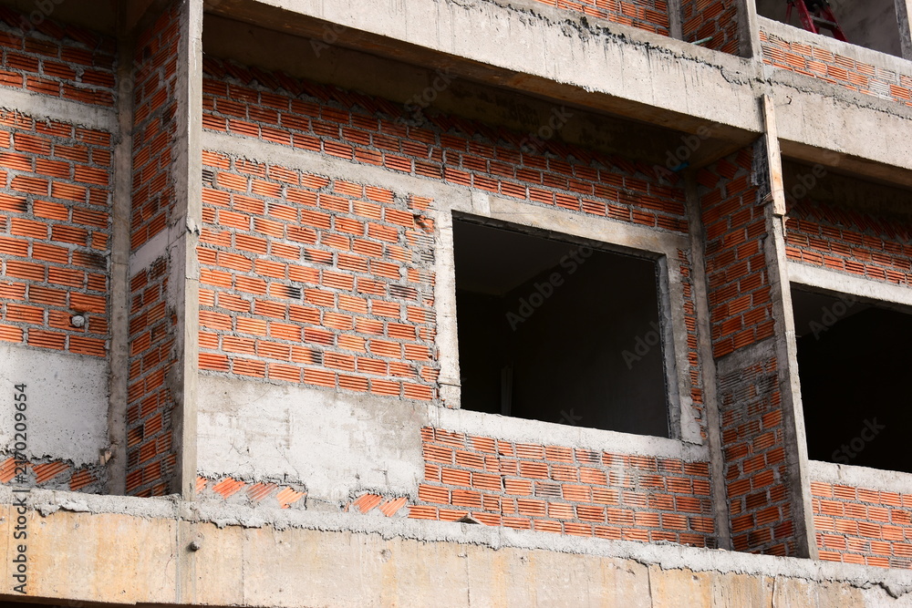 Fototapeta premium exterior view of brick house under construction with concrete structure