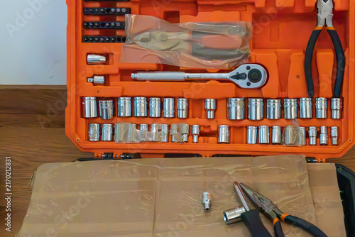 Obraz na płótnie Macro close-up of an open orange tool box containing a socket wrench set