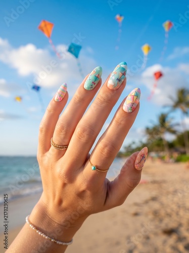Woman Hand Displaying Colorful Summer Nail Art at Tropical Beach with Kites