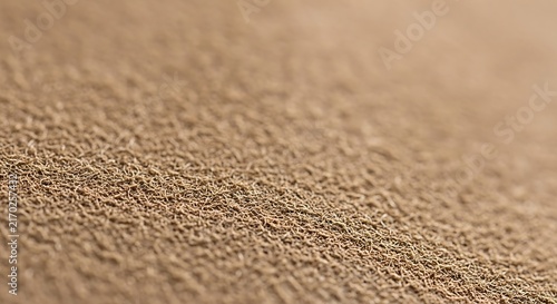 Close up macro view of textured beach sand surface with background, abstract
