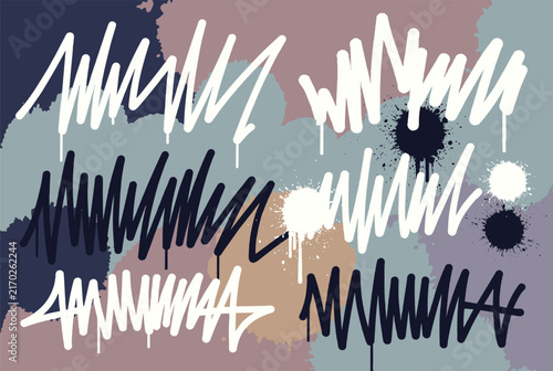 Urban graffiti background featuring chaotic spray paint scribbles and splatters in white, black and blue on a multicolored wall.