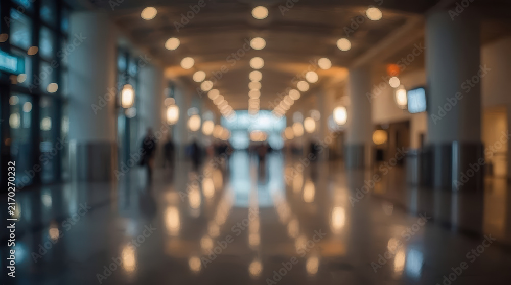 Fototapeta premium Blurred convention center hallway with modern architecture and warm lighting