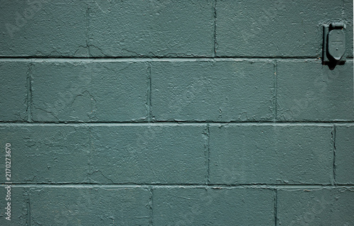 Konstfotografi Minimalist teal painted cinder block wall background texture featuring an outdoor electrical outlet cover with copy space