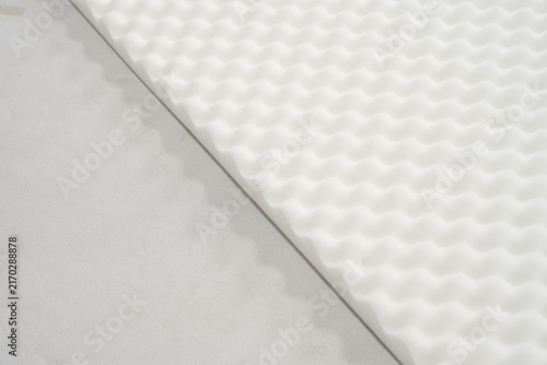 Фотография Close-up of white convoluted egg crate foam topper layer for mattress, bedding m