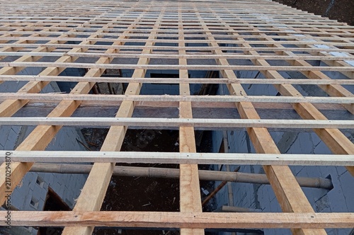 Obraz na plátně Construction of a wooden roof frame and batten grid on a residential building un