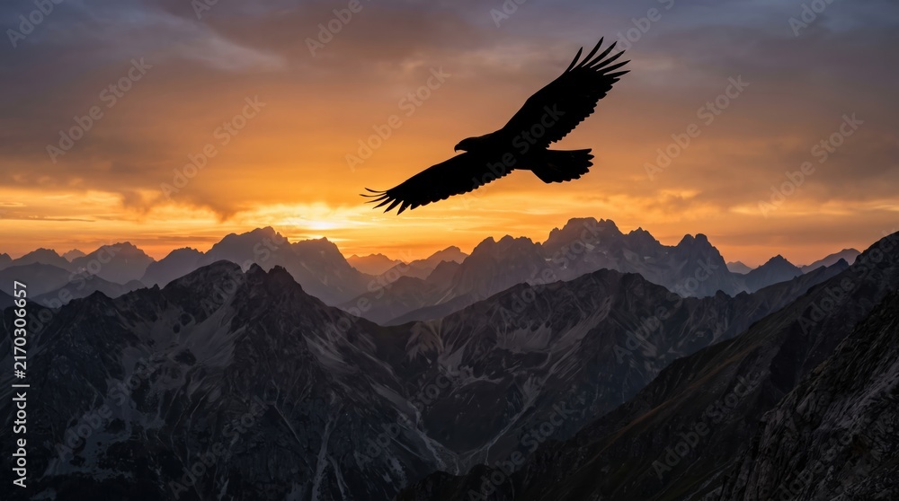 Fototapeta premium Eagle flying over mountains at golden sunset