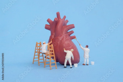Картината върху платно Miniature maintenance workers cleaning and maintaining a human heart model, concept of cardiovascular health, heart care, and cardiology treatment
