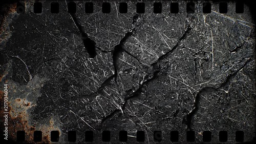 Close up of scratched dark metal surface with rust and vintage film strip border texture