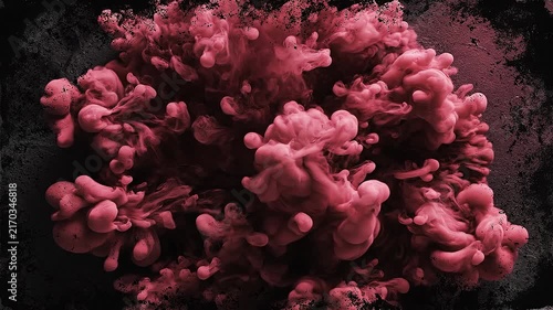 Abstract pink ink cloud swirling in dark textured background artistic fluid motion