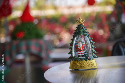 Close-up view of Christmas gifts under a decorated tree with red wrapping in a cozy home interior.