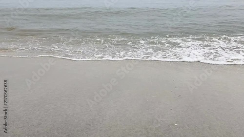 Ocean waves washing onto a sandy tropical beach