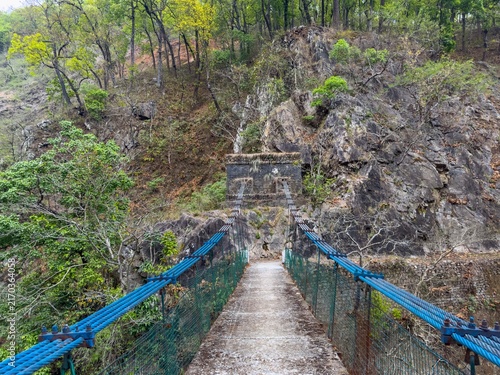 Photography Iron wire bridge over the river on hills. Engineering concept.