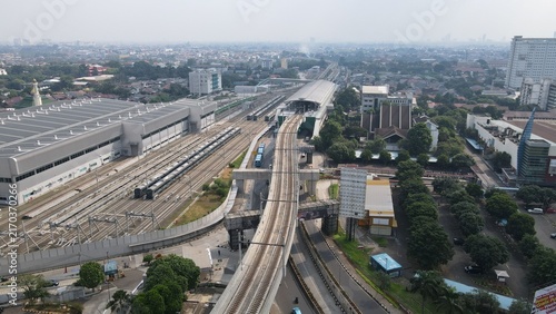 Aerial view of Stasiun MRT Lebak Bulus with elevated train tracks and modern station architecture in Kecamatan Kebayoran Lama, Daerah Khusus Ibukota, Indonesia.