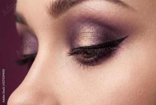Plakat w ramie Close-up of Woman Eye with Professional Purple and Gold Metallic Eyeshadow Makeup